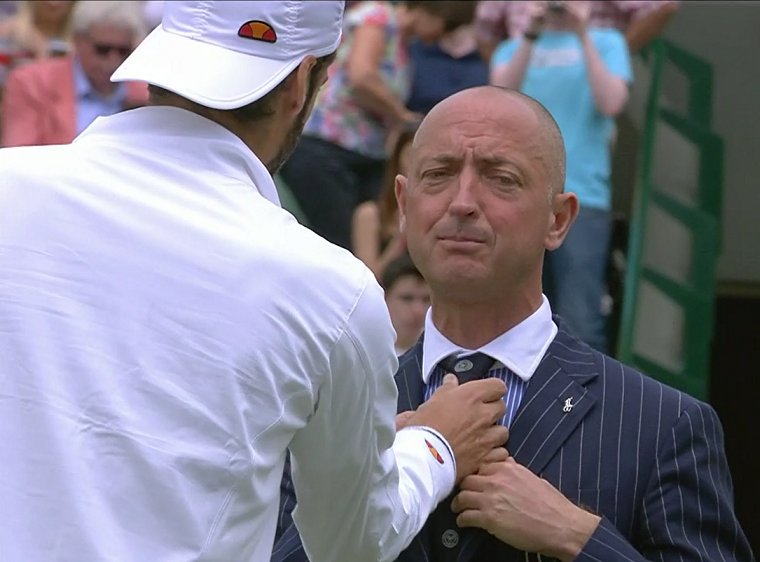 A beautiful man teaching tennis scrubs how to do the tie r