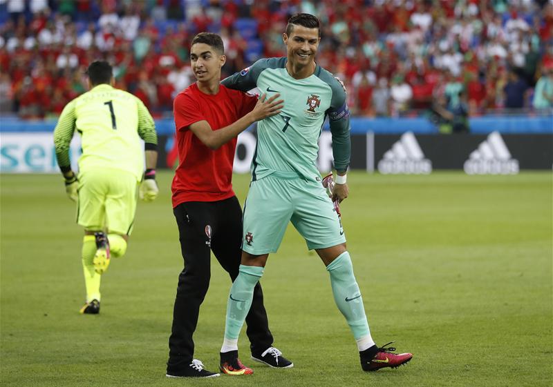 plessbol's tweet photo. RT @101greatgoals: Cristiano Ronaldo brilliantly deals with a pitch invader before #PORWAL https://t.co/sqmyd6pBEV