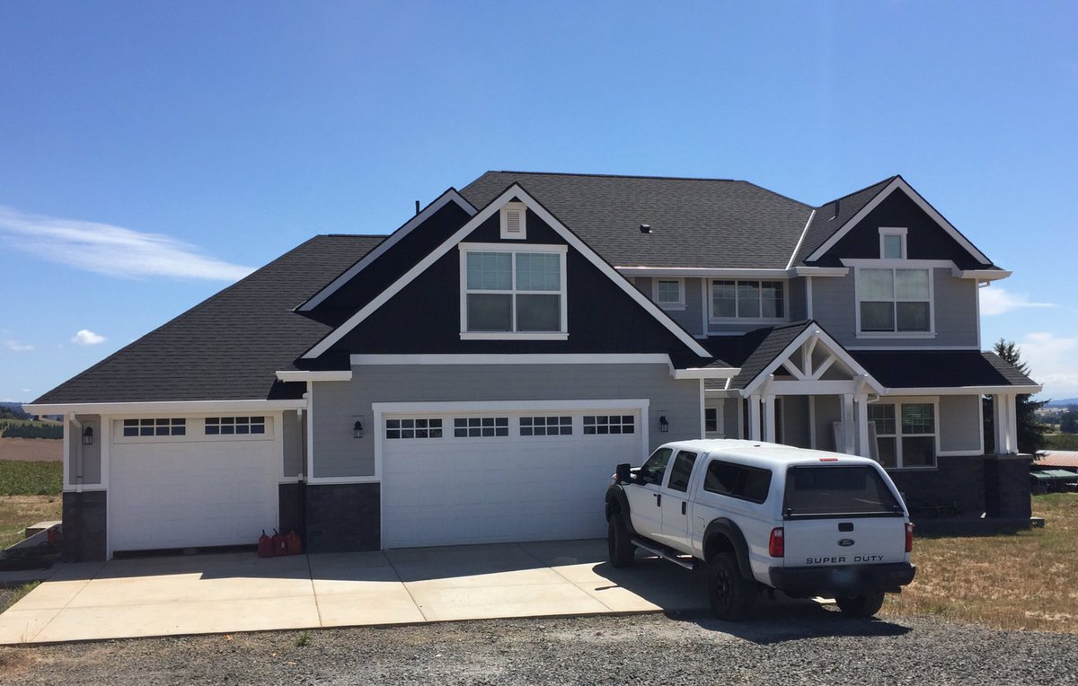 White fascia gutters &amp; downspouts on a beautiful home in Banks, Oregon