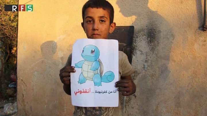 Syrian children holding Pokemon photos in hopes the world will find them and save them