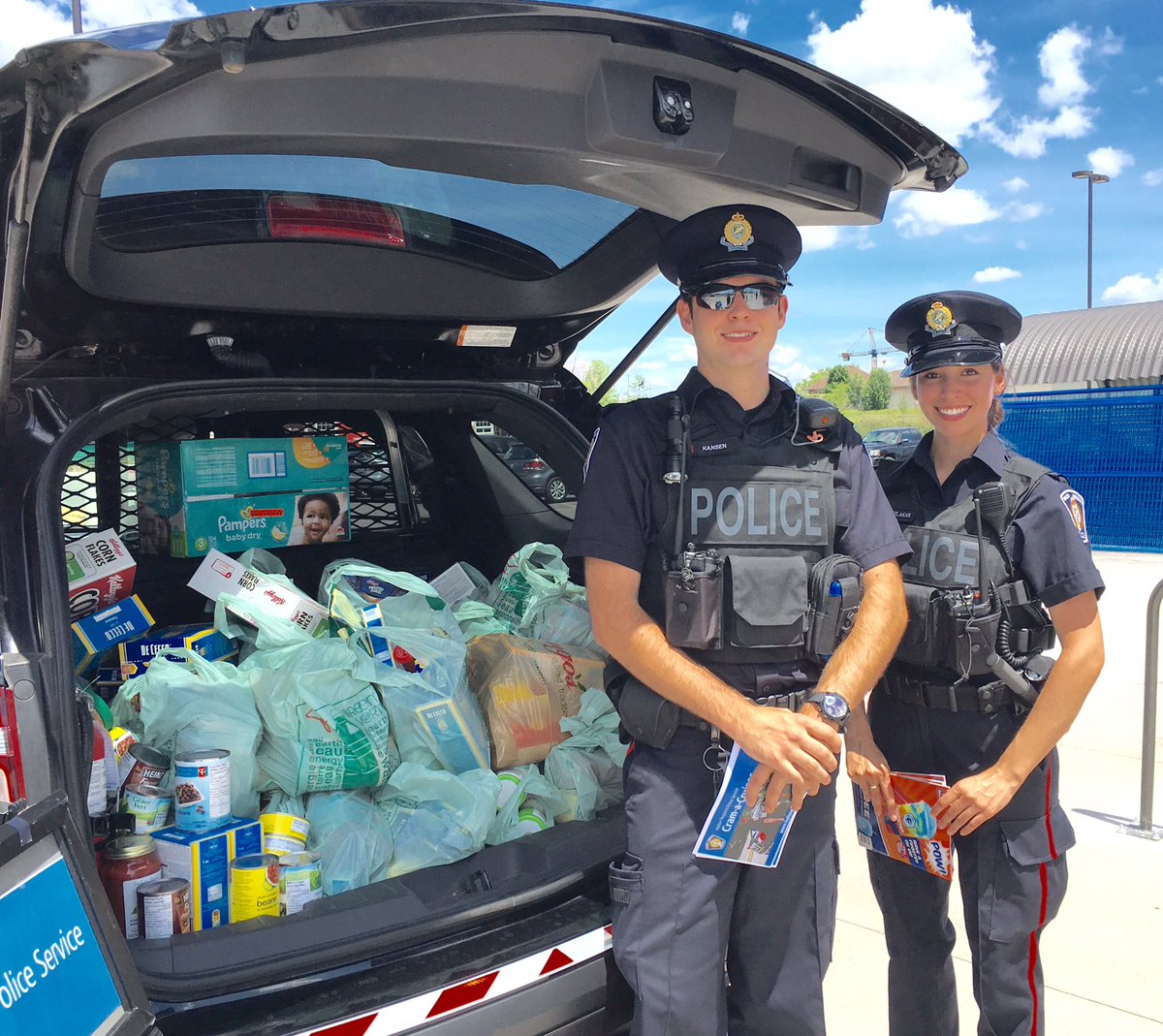 HRPS_Traffic's tweet photo. Cadets Hansen &amp; Izlakar stand with a full cruiser going to local food banks #CramACruiser ^ao https://t.co/m9nd4fwc9o