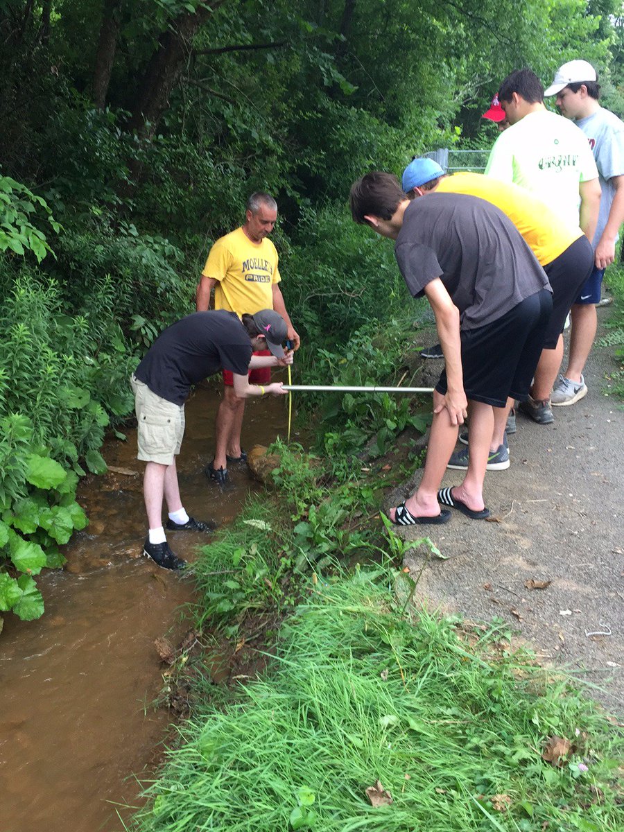 Men of Moeller rebuilding a fence in Barbour County with <a href="/M25M_org/">Matthew 25: Ministries</a>  during their summer service trip.