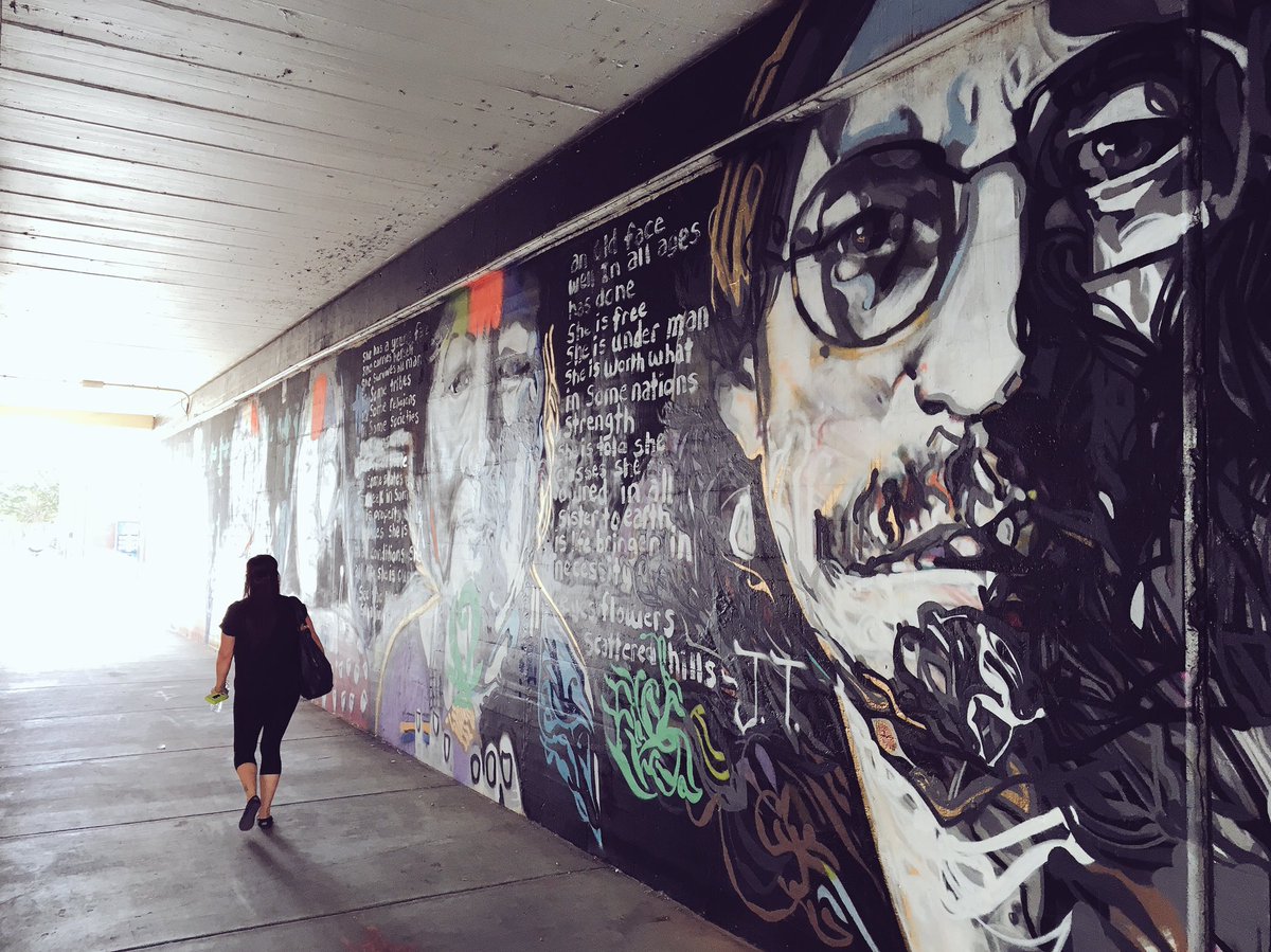 DowntownOKC's tweet photo. Gallery labels being installed for the Sheridan Underpass murals. #NativeMuralOKC https://t.co/ZbEMP50sXe