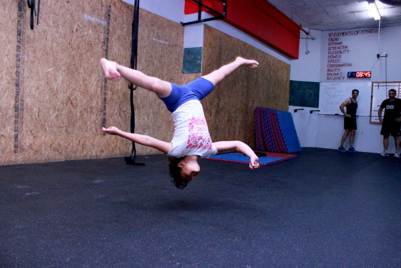 CrossFit's tweet image. "Nine-and-a-half years old joins her dad at the box during summer holiday." —Oren Schneider, @CrossFitWhiteCi