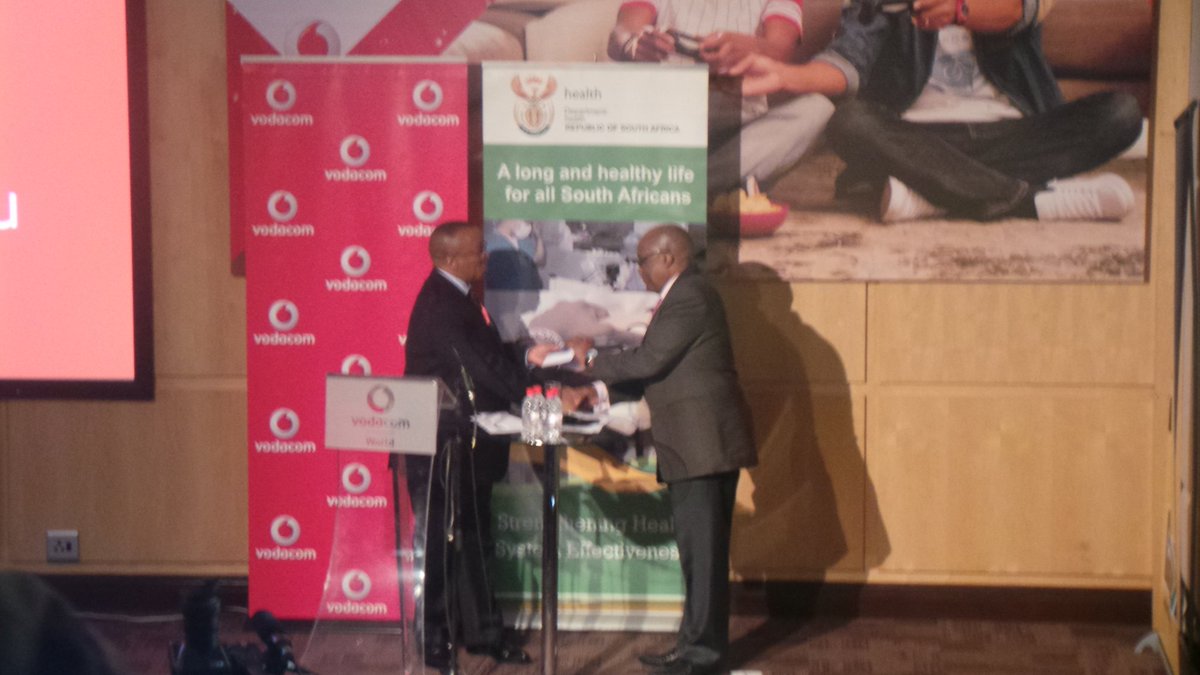 HealthZA's tweet photo. Dr. Bada Pharasi, handover of RxSolution document to Dr. Aaron Motsoaledi. #HealthInnovation ^eN2 https://t.co/3pT9oaX7XN