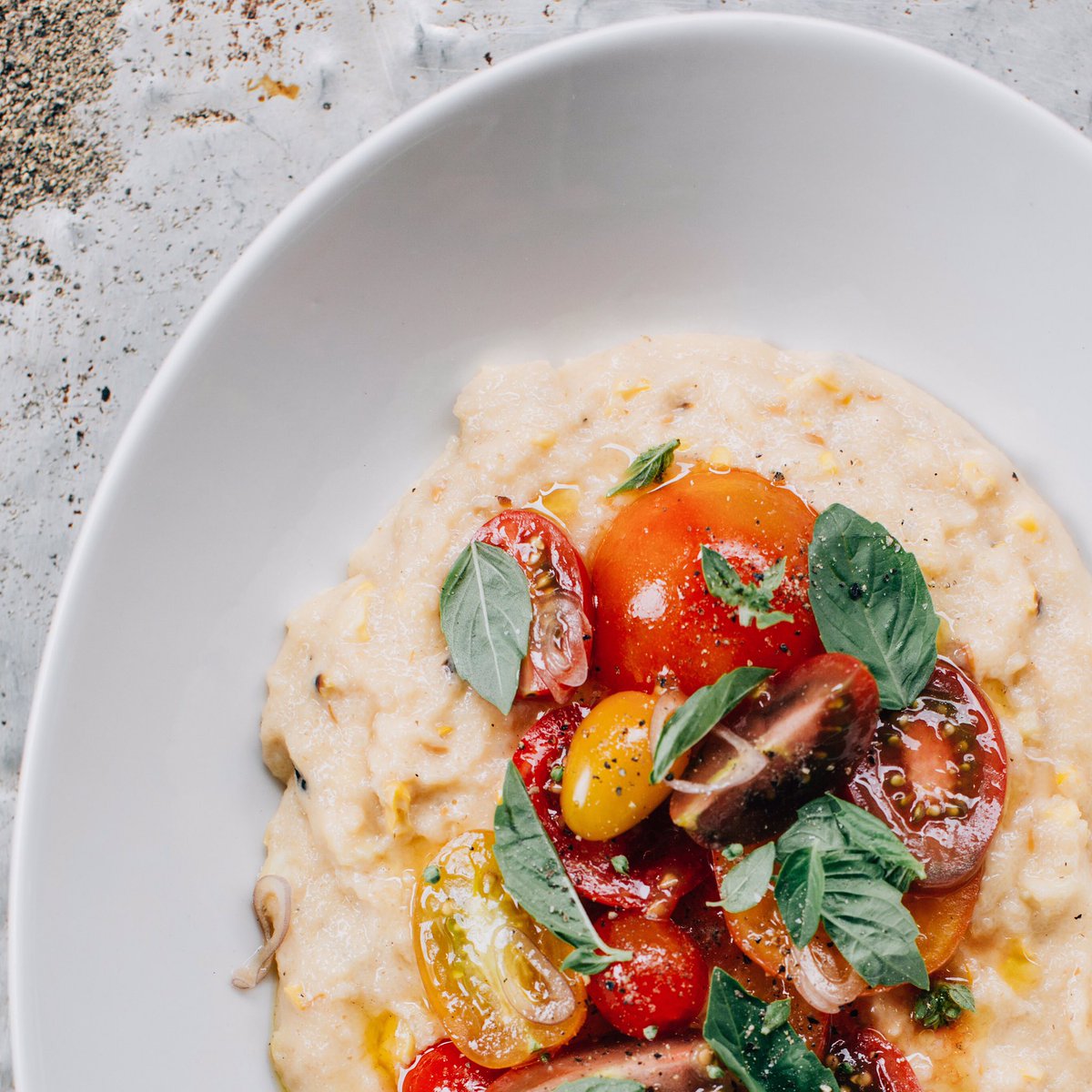 smoky sweet corn farina with marinated heirloom tomato salad from #newmedtable starting this weekend @saffronmpls