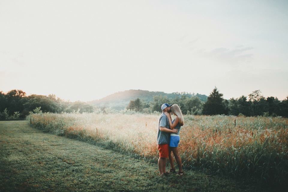 Ellesse and Chris's engagement session. We love this shot in the hay field at sunset. #Nashvilleweddingvenue
