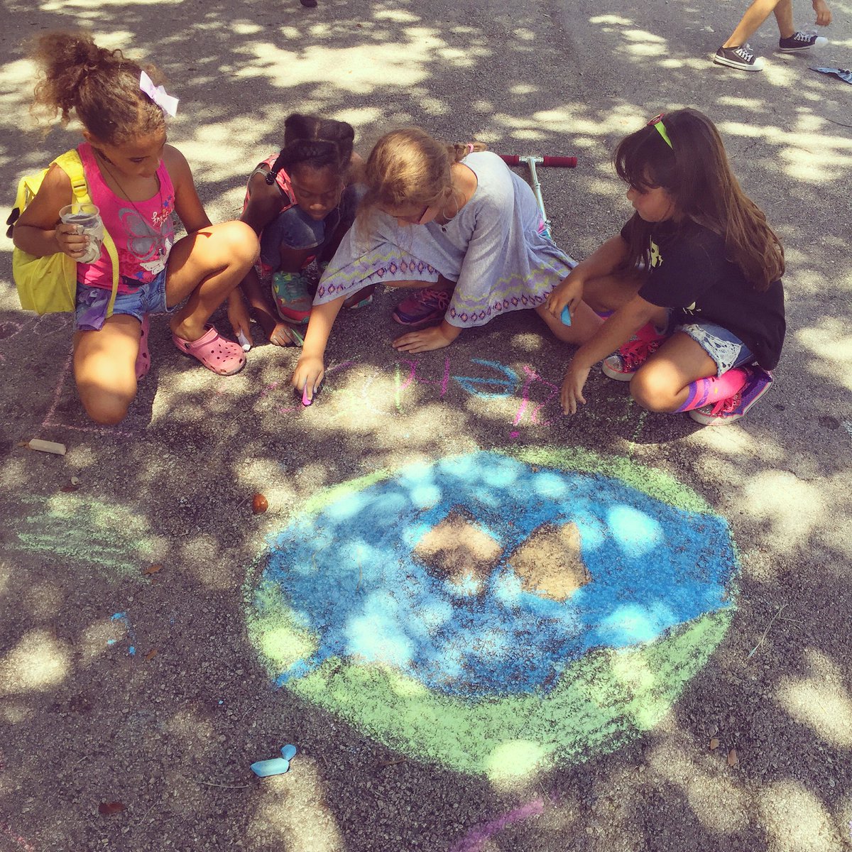 ColorRCommunity's tweet image. A favorite moment. They worked together to draw #earth w open arms then took turns to spell friendship. #ClrRCmmnty