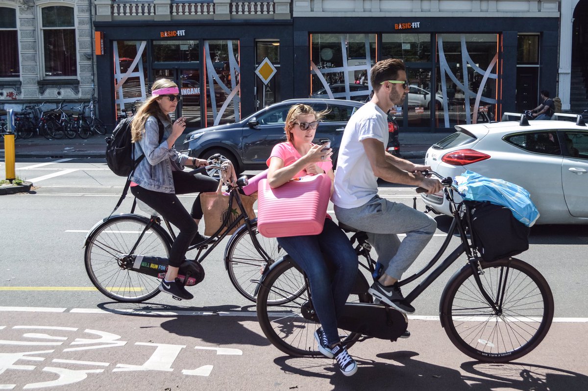 modacitylife's tweet photo. "Dinking" (or doubling) may be the ultimate indicator of a bicycle-friendly city. And in Amsterdam, it's everywhere. https://t.co/FK78UU1ebv