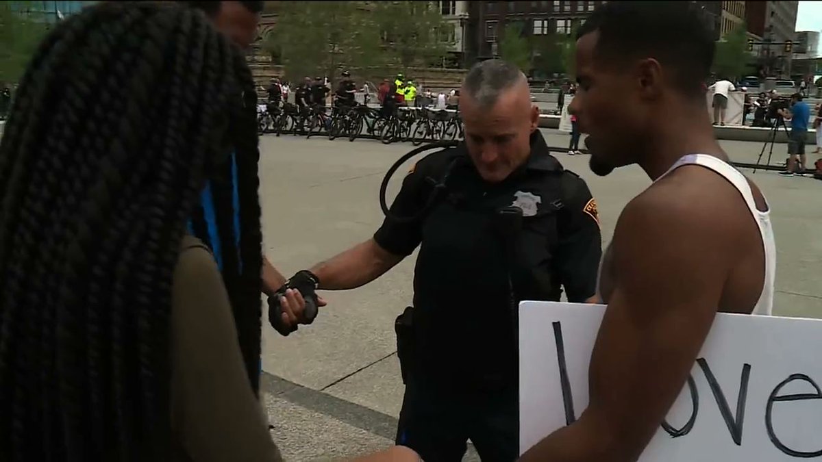 WGNNews's tweet photo. WGN video of white officer, black demonstrators praying for peace goes viral https://t.co/2dJyaXpRAd https://t.co/K3IxzTfhtU