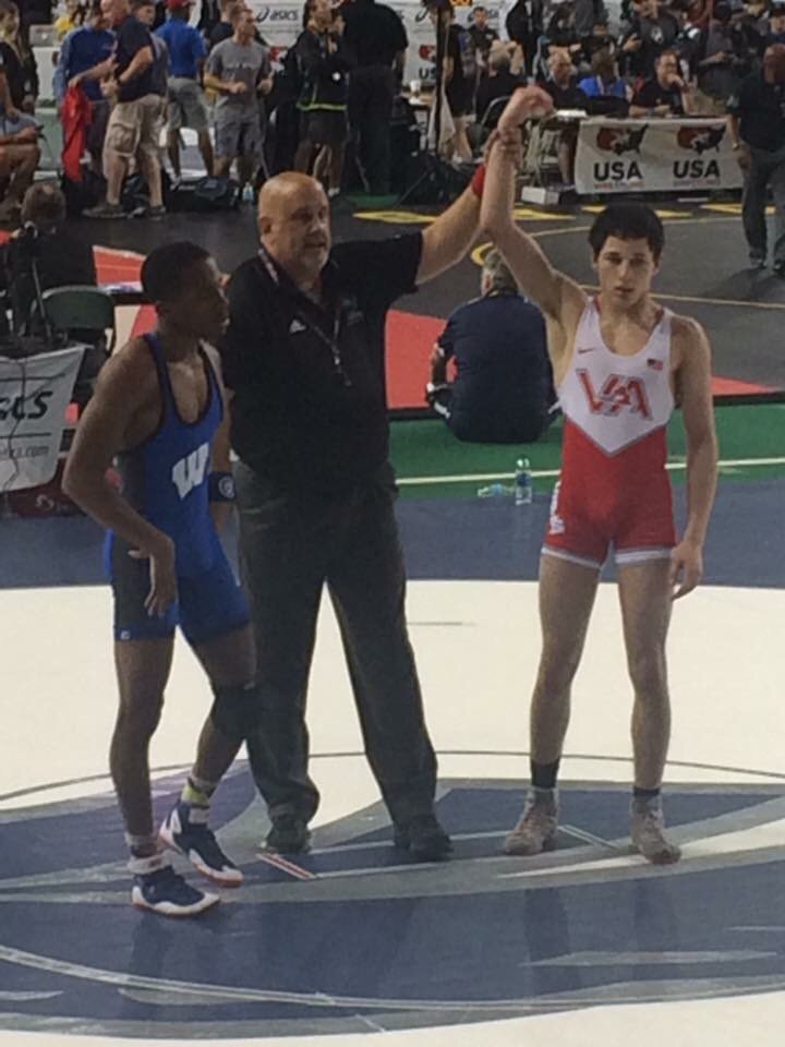 Grant Saunders gets his hand raised over Wisconsin state champ in first round action in Fargo