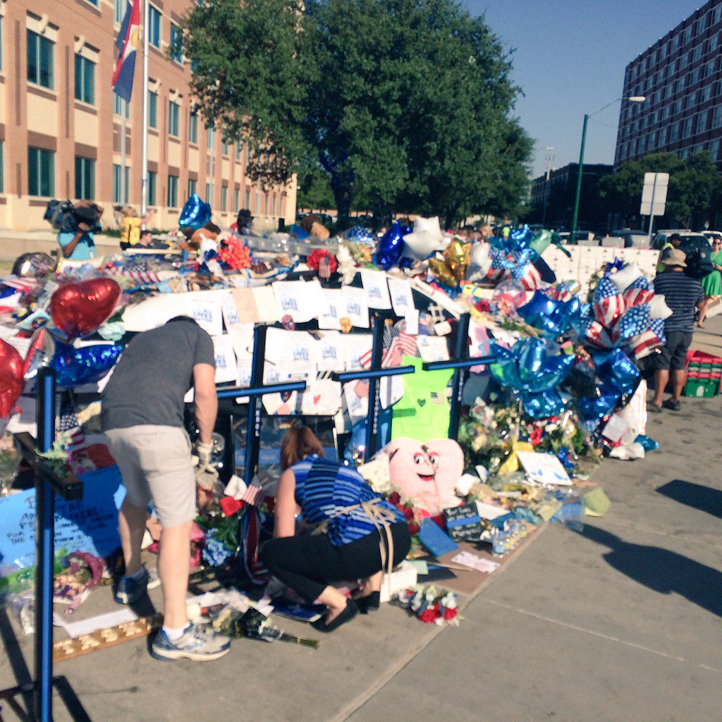 DallasPD's tweet photo. The picking up of items has begun. #DallasStrong https://t.co/bRYOFiS7Cy