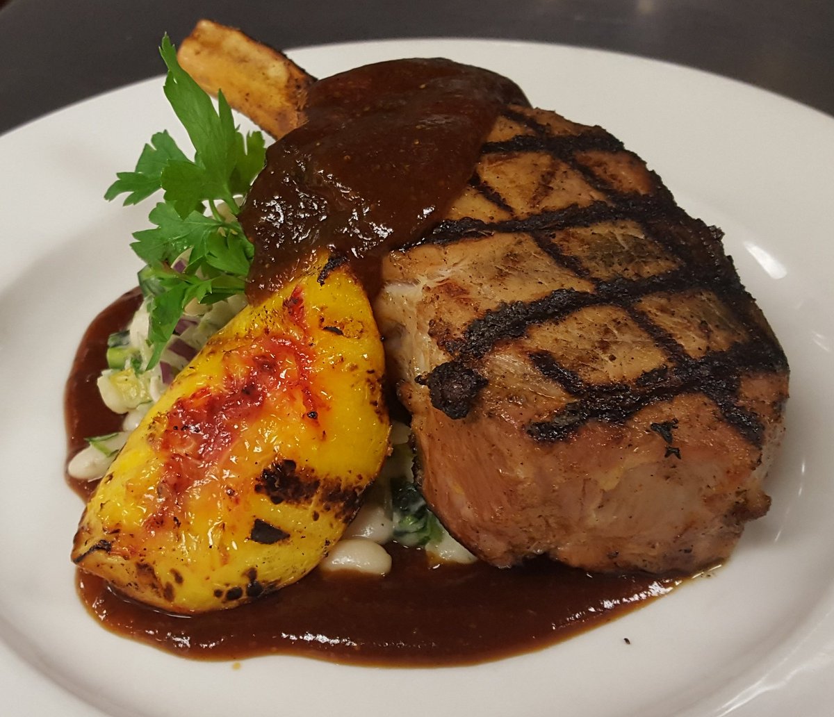 ChefMegBickford's tweet photo. @CafeAdelaide Smoked Double Cut Pork Chop, LA Fig BBQ, Charred Peach, Truffled White Beans #CoolinaryNOLA https://t.co/jxiTmM7eko