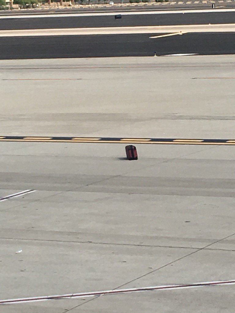 CVPerformance's tweet image. Gate A27 at PHX @AmericanAir left someone's bag on the tarmac. Hope it's not yours. #americanairlinesfail