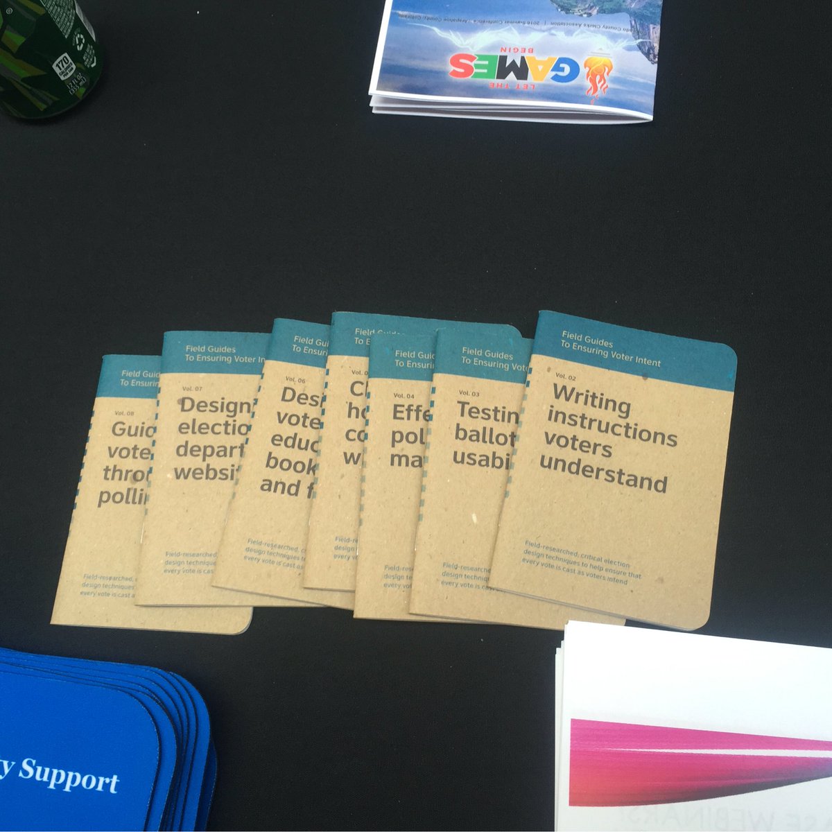 A table in the conference hall displays the collection of Field Guides