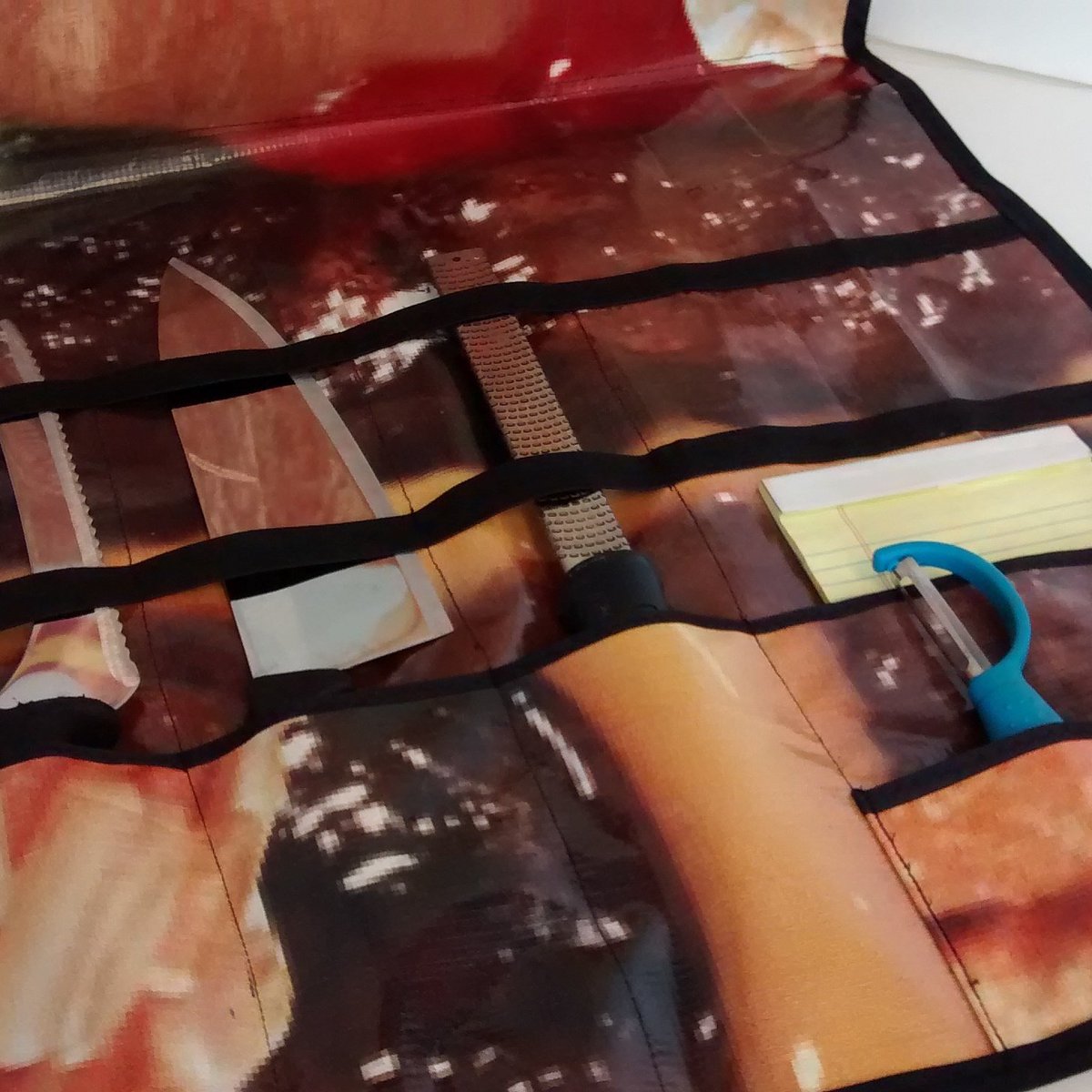 Product design and prototype sewing is happening. Today - a fast food billboard repurposed into a chef's knife roll!