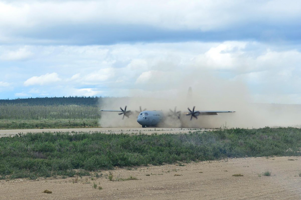 DeptofWar's tweet image. A C-130J lands on a dirt landing strip in Alaska to simulate realistic conditions in deployed locations.