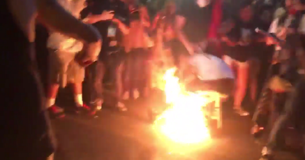 Black lives matter terrorist stomps burning flag, catches fire VIDEO