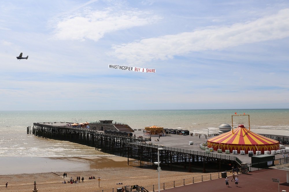 Hastings_Pier's tweet photo. What a shot - #HastingsPier flying high! There’s only 4 days left in our #CommShare offer https://t.co/tORj5LTLuT https://t.co/1OCQuMWW7b