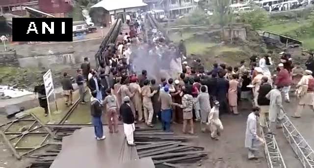 ANI's tweet photo. Angry over rigged PoK elections, locals burnt Pakistani flag in Neelum Valley (PoK) and faced police action. https://t.co/TYqVZgnzQD