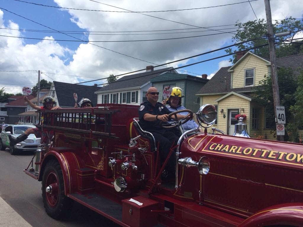 ChtownFire's tweet photo. FF Flanagan on the LaFrance with Councillor Rice, Ministers @RichardBrownPEI and @TinaMundy in the @PRIDEPEI parade. https://t.co/D2dXvtV8Mz