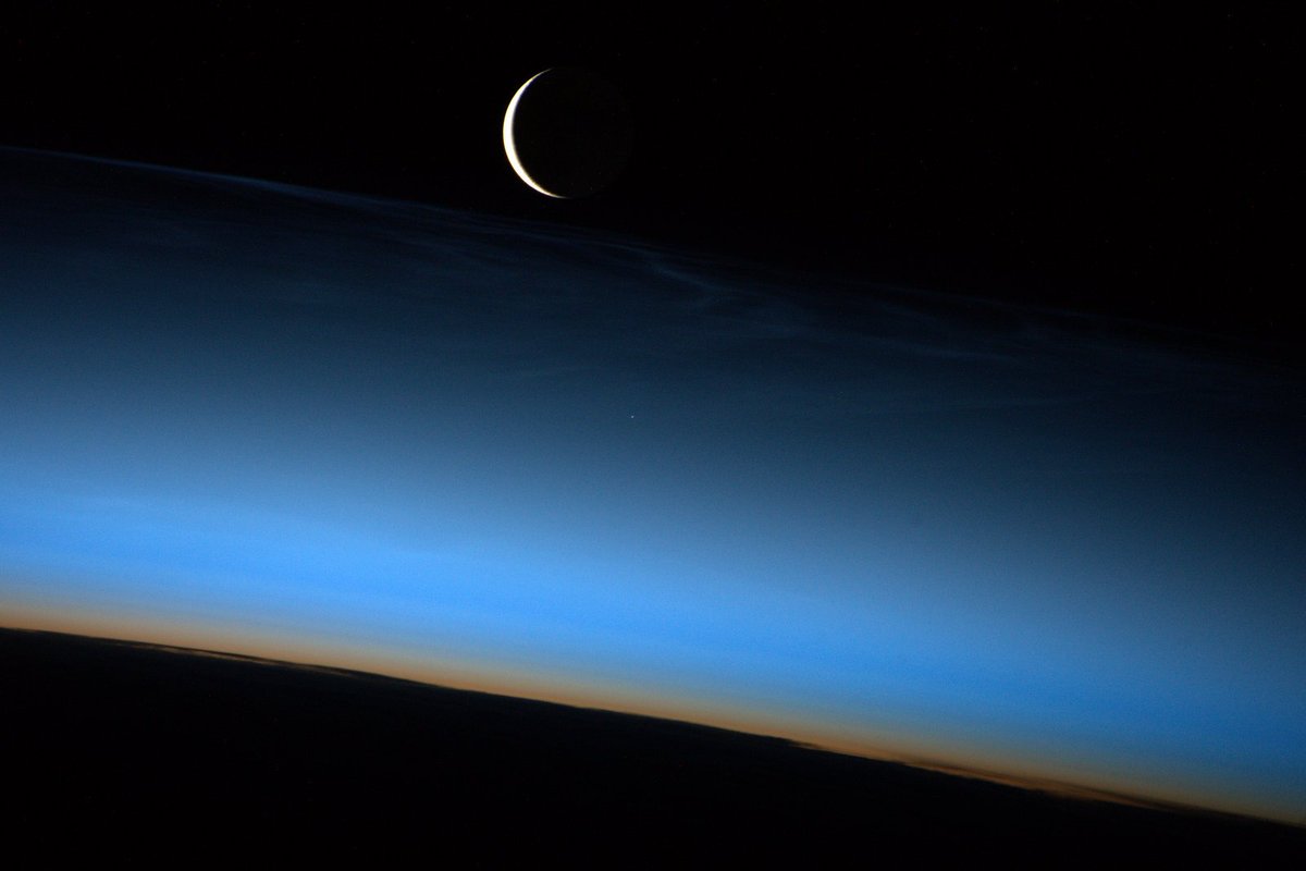 Astro_Jeff's tweet photo. Crescent Moon rising through a subtle display of noctilucent clouds. https://t.co/WWASLTSFGR