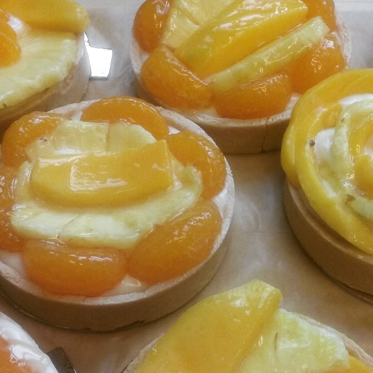 To get your tastebuds talkin..try our Tropical Fruit Tarts! #Pastry #vanillapastrycream #pineapple #mango #tangerine