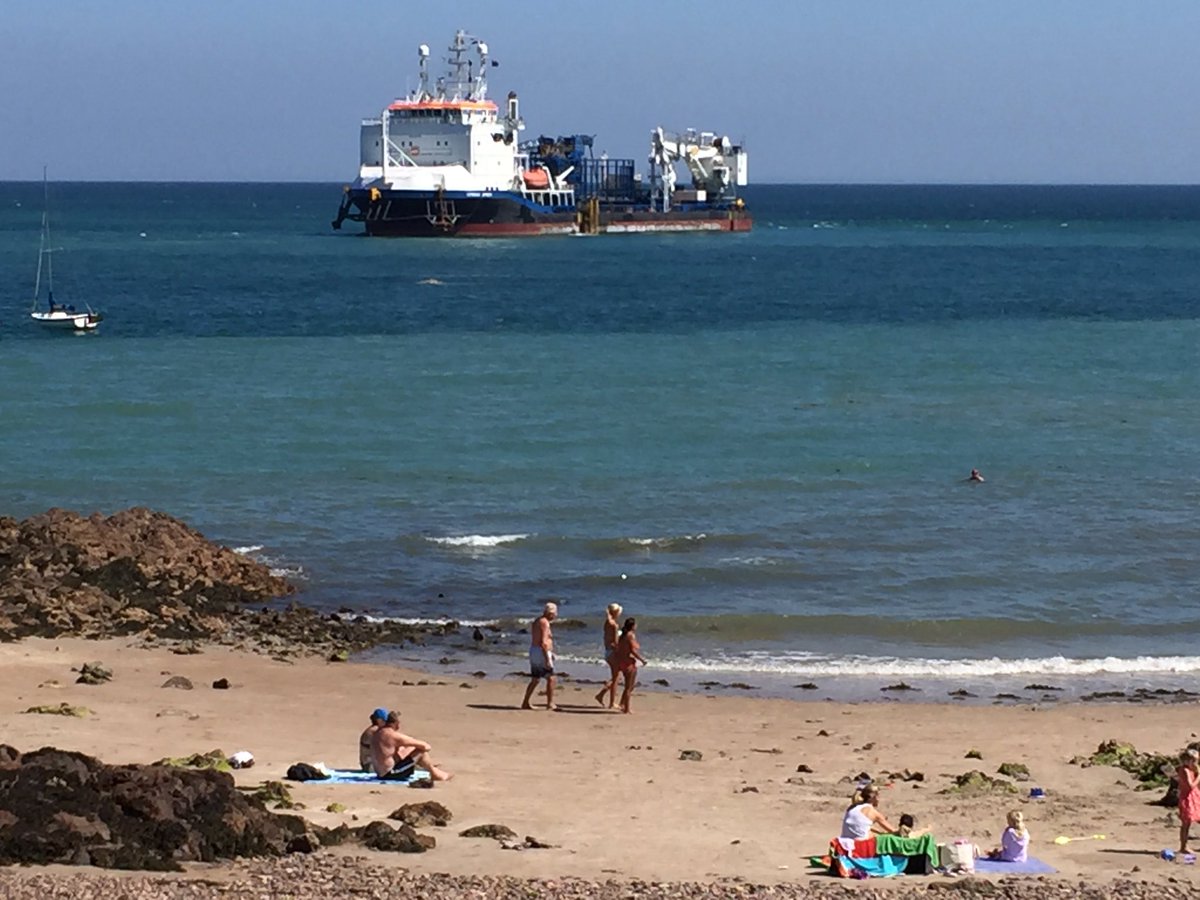 Cablelaying vessel Stemat Spirit moves slowly across Archirondel as it nears the end of its 27km journey from France