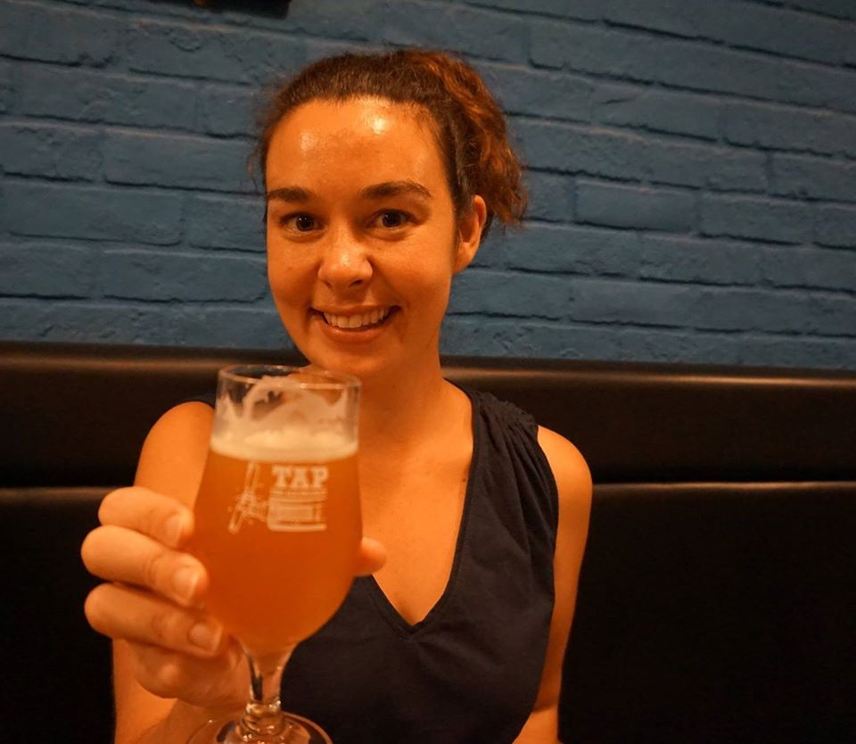 Our guide Jess doing very necessary research on the best locally brewed beer in preparation for our night tour!