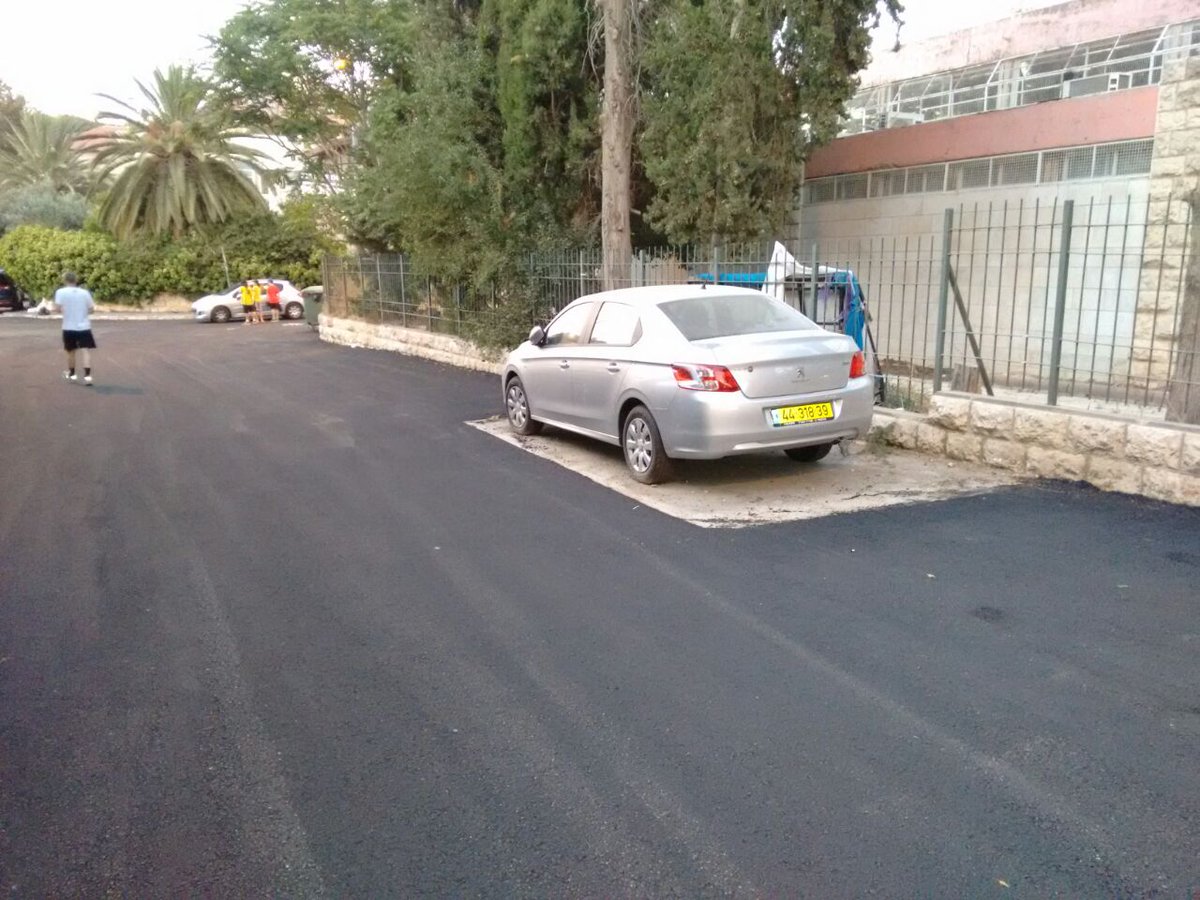 superpharm's tweet photo. Seen in Jerusalem today. Easier to tarmac around than to move this car. Great image from Adir https://t.co/sm7dGW28Ou