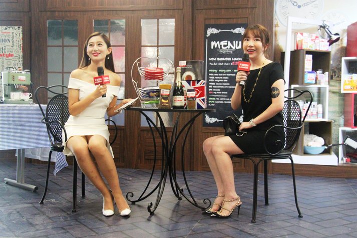 Former Miss Chinese New York Nicole Wang (r), a devoted Alibaba shopper, tours the EU pavilion at Tmall's 8.8 fest.