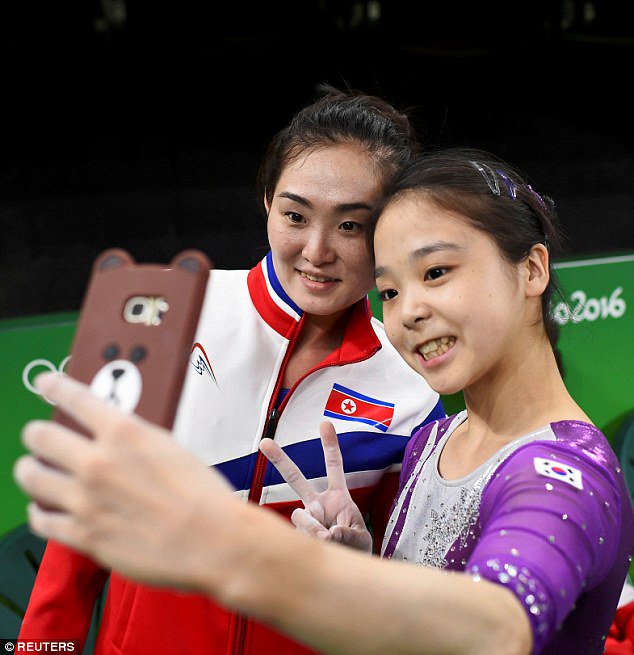 DailyMail's tweet photo. North and South Korean gymnasts put politics aside to take a selfie together https://t.co/DI92GadDwf #Rio2016 https://t.co/AbXntmpnuk