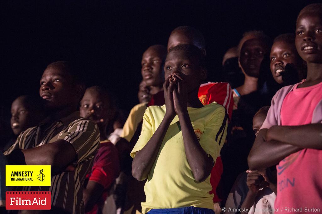 Refugees proudly cheer on #TeamRefugees at #Olympics screenings in Kakuma Refugee Camp in #Kenya thanks to <a href="/FilmAid/">FilmAid</a>