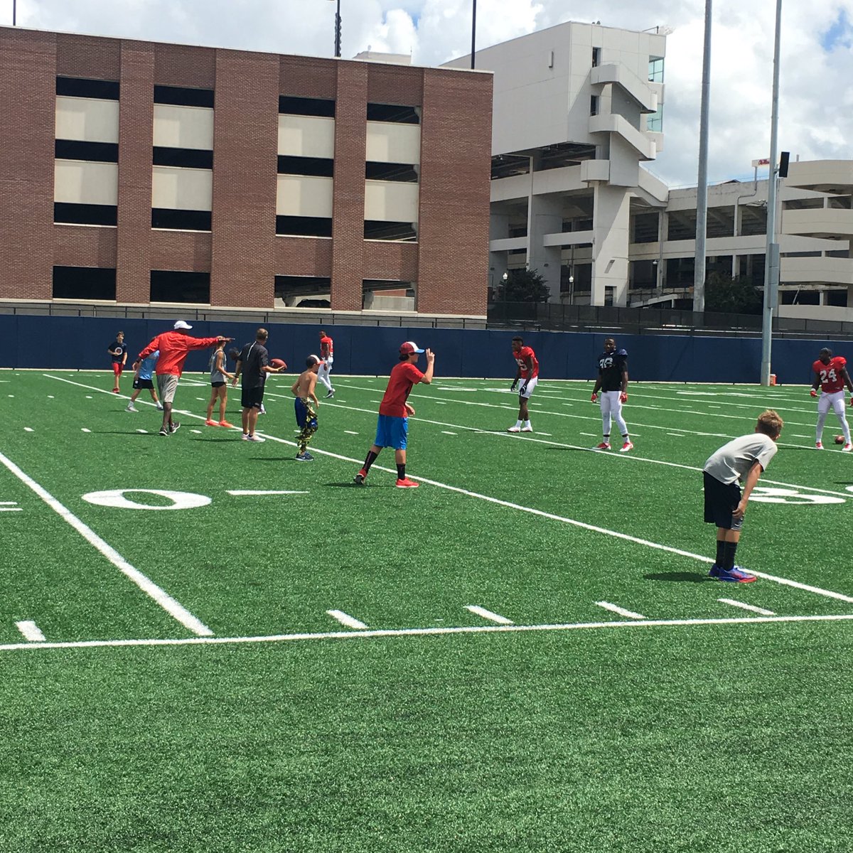 YancyPorter's tweet photo. #OleMiss head coach Hugh Freeze playing 7 on 7 with the kids from the Farese and Perry family at today's practice. https://t.co/E3JJ8GgfLn