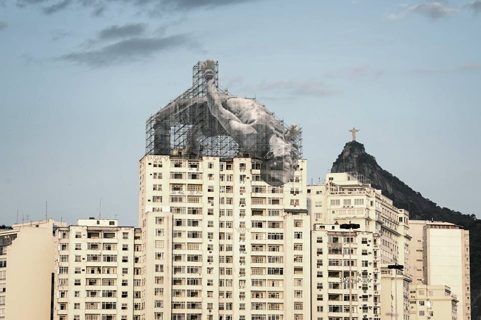 Robertdreco's tweet photo. #OlympicArt is all over Rio - Check out these two Giants getting active in Rio. JR Artist https://t.co/10s8LBEWod