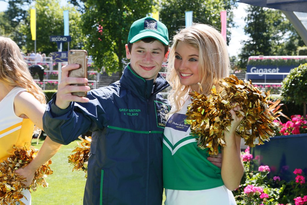DDFRacing's tweet photo. Luck of the Irish! Oisin Murphy gets a selfie with one of the #TeamGBI cheerleaders. #DDFSC https://t.co/JYdU0zJTe7