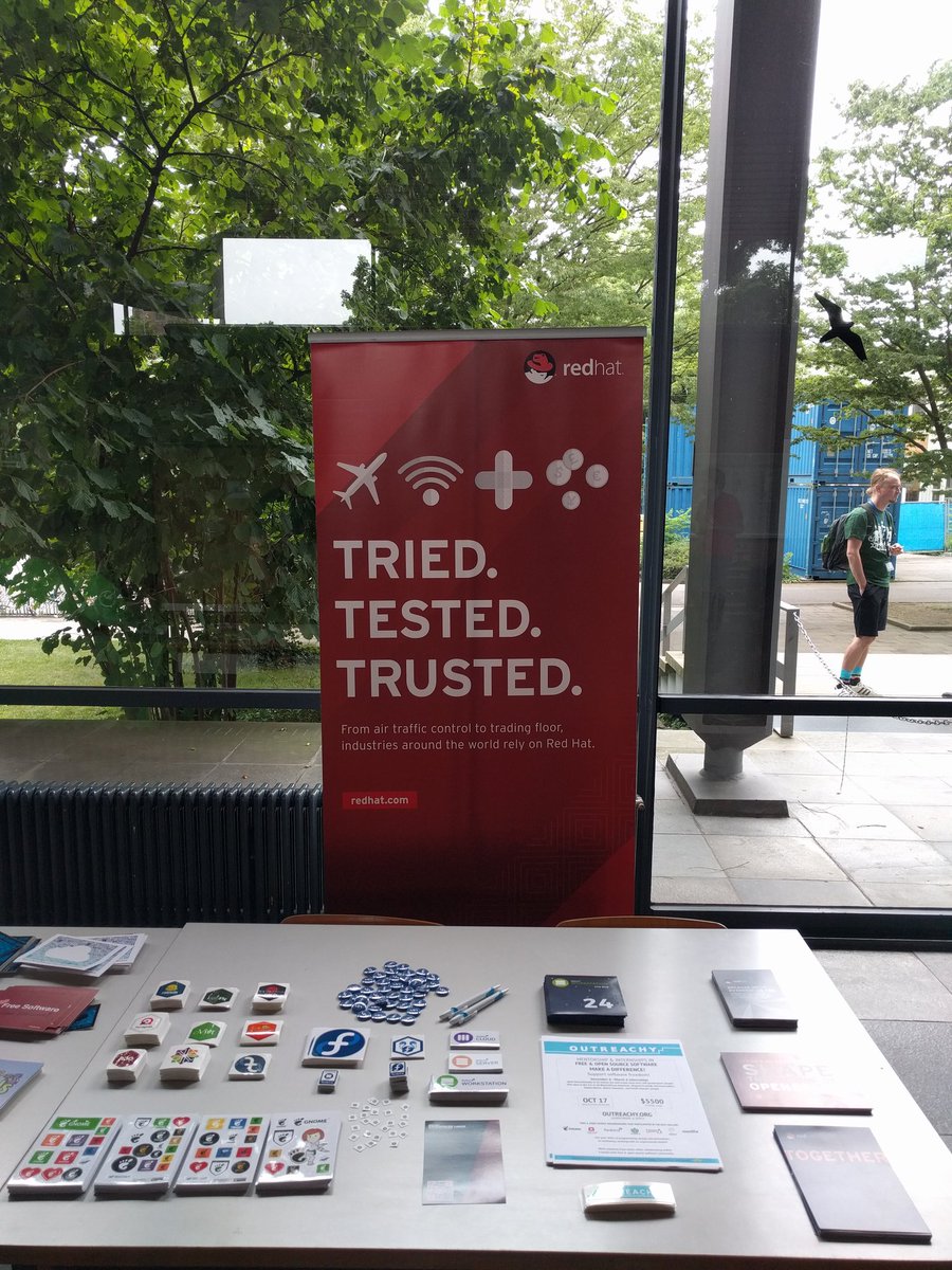 marinaz's tweet photo. Loving a well-stocked @RedHatOpen table at @guadec, with many community stickers. Thanks @JenInnovate &amp; @GinaLikins! https://t.co/QQHLz4u6cK