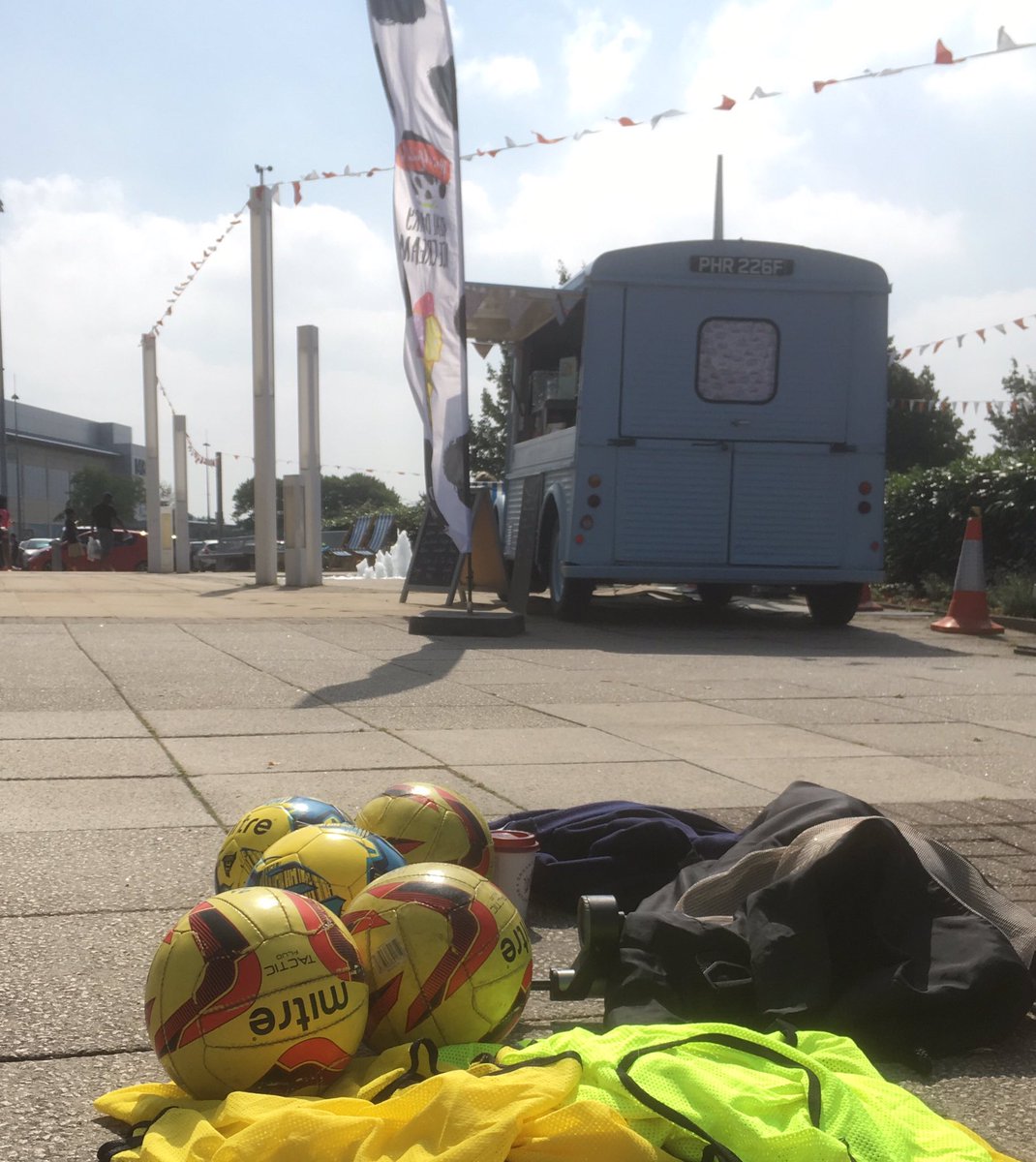 Next to our ice cream van @mallcribbs customers are dribbling around cones.......in the football coaching session.