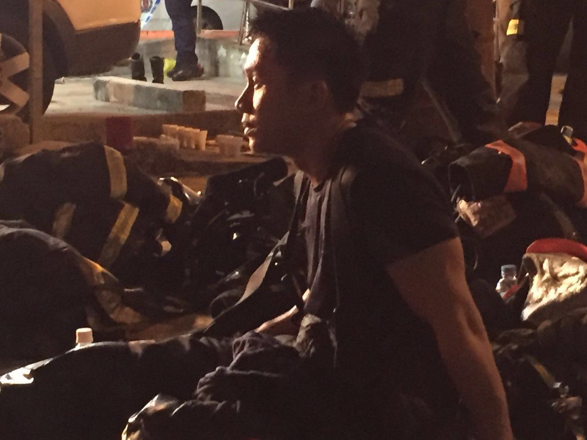 SCDF's tweet image. Firefighters having dinner and resting before being redeployed into the building to continue the ops.