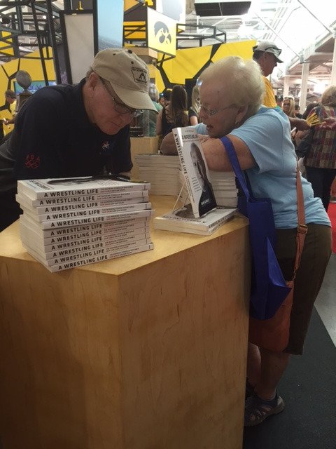 RickKlatt's tweet photo. A bigger than life Iowan talks @uiowa and @Hawks_Wrestling with a fan today at the #HawkeyeStateFair. https://t.co/ahMUTYrb1L