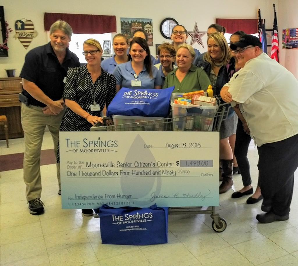 S_Mooresville's tweet photo. Presenting the Mooresville Senior Center with a check for $1,490 and 438 lbs of food for #independencefromhunger https://t.co/iWKAdZgfaS