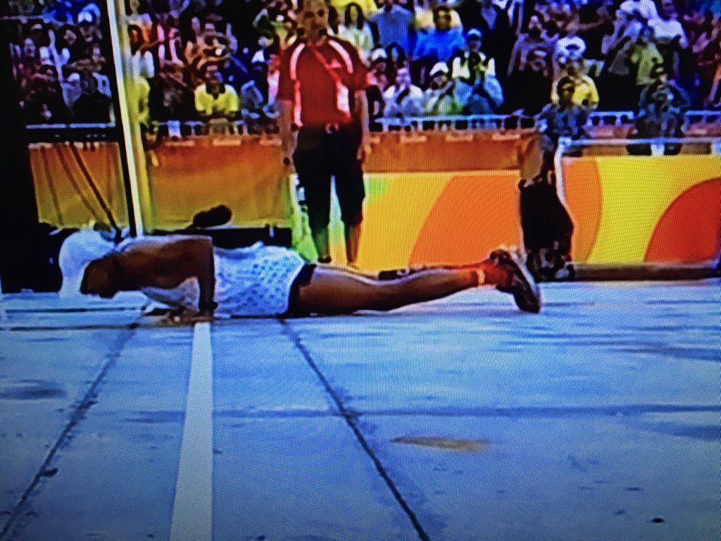 Meb slips and falls at finish, does three push-ups, finishes.