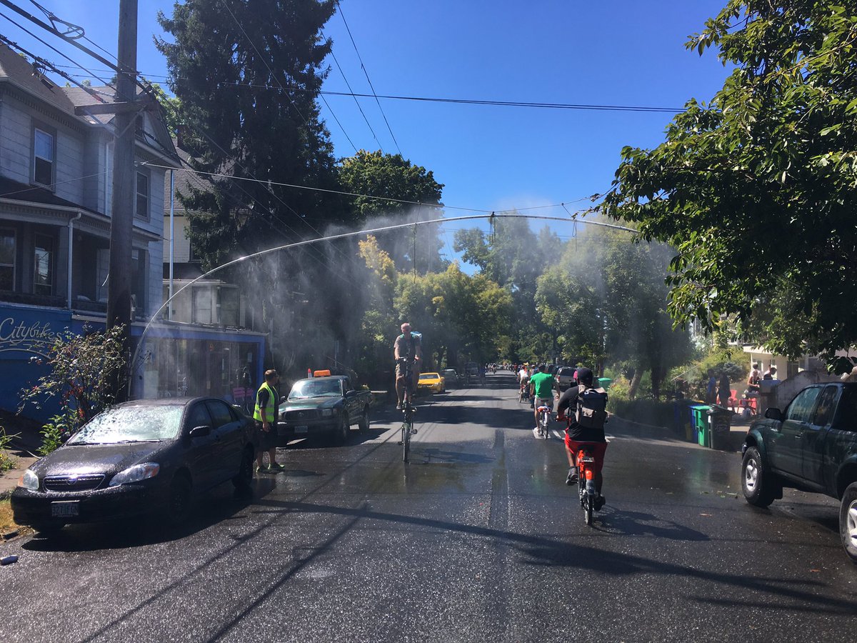 MikeLydon's tweet photo. That's @ctbrown1911 cycling through the @SundayParkways street soaker. #OpenStreetsPDX https://t.co/7H8uWc3bfH