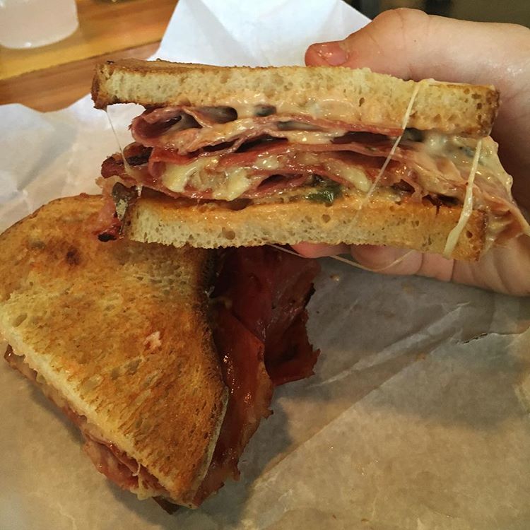 Our hot reuben: corned beef, melted provolone + sauerkraut on rye. Photo courtesy of the <a href="/nyckitchen/">NYCCommercialKitchen</a> on Instagram.