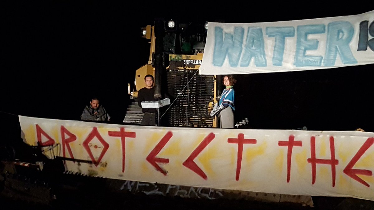 UR_Ninja's tweet image. At least six ppl currently locked down to Dakota Access Pipeline construction #NoDAPL