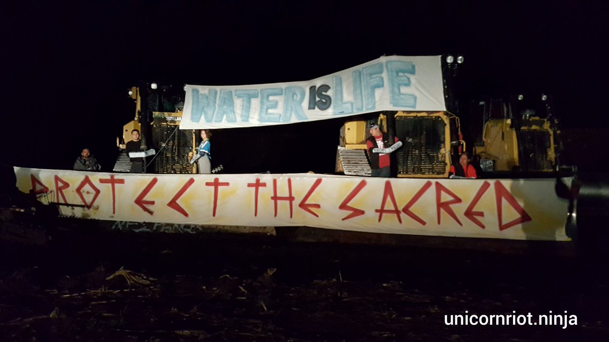 UR_Ninja's tweet image. At least six ppl currently locked down to Dakota Access Pipeline construction #NoDAPL