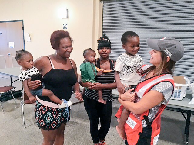 We're all smiles @ Heymann Shelter today where #Redcross is providing food, diapers & other items to this family ❤️