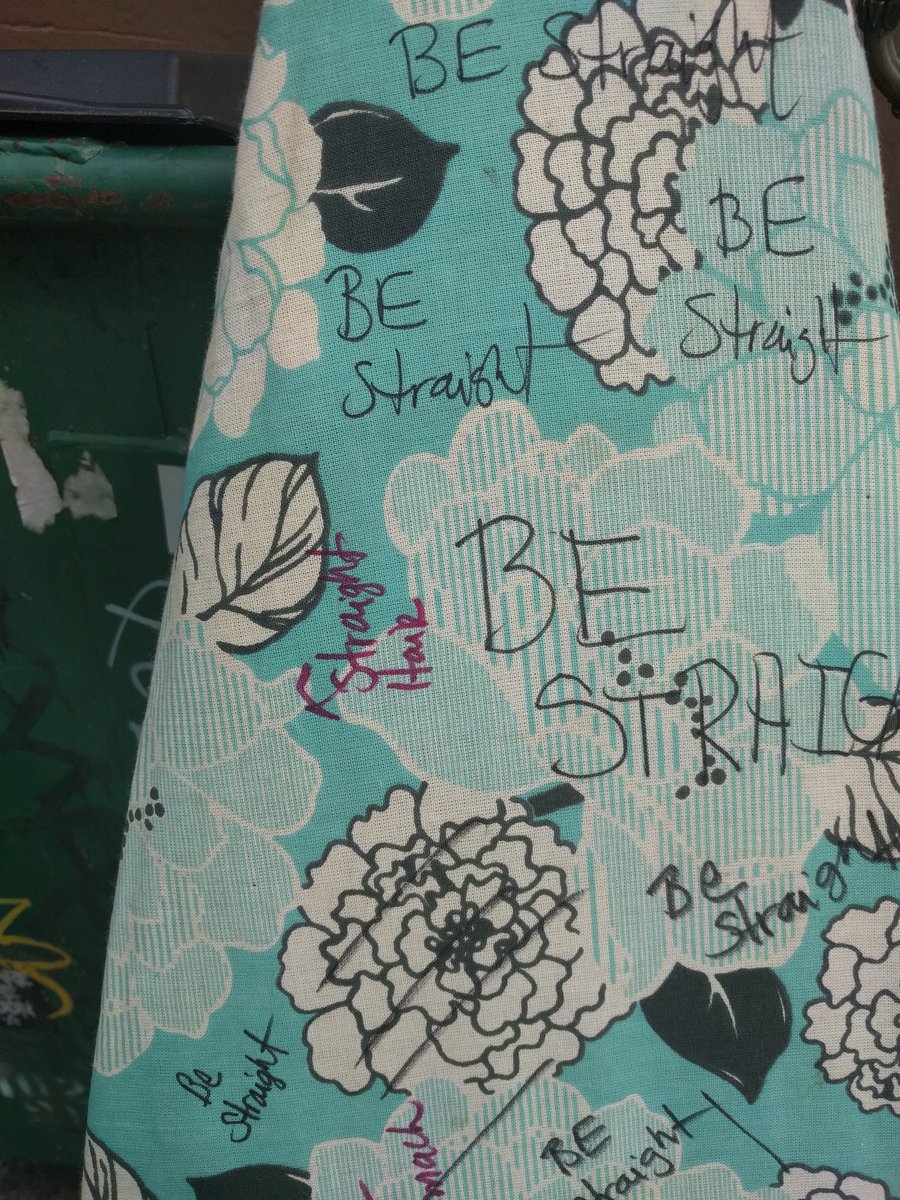 close-up of ironing board with sharpie marker writing "be straight" in many places