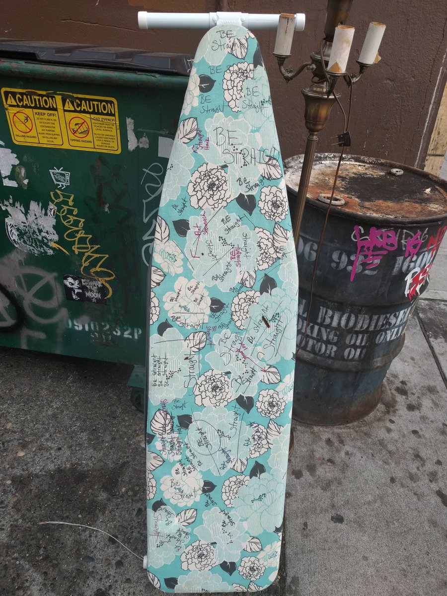 ironing board with sharpie marker writing "be straight" in many places
