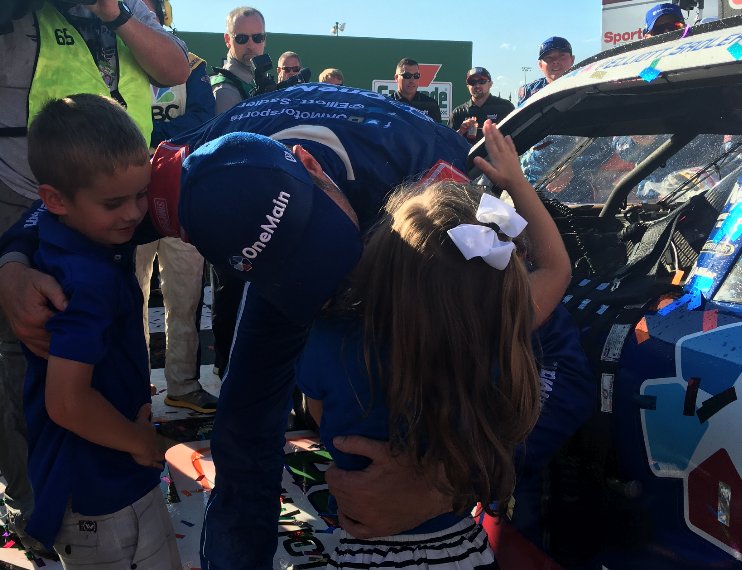 XfinityRacing's tweet photo. .@Elliott_Sadler savors every moment with his kids in #XFINITYSeries Victory Lane. #KidsDriveNASCAR https://t.co/EiYNMEihly